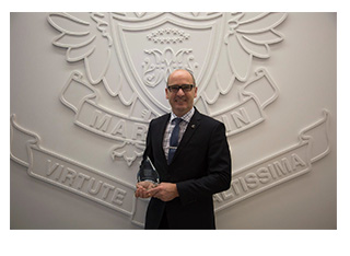 Image of Principal from Marcellin College with his award.